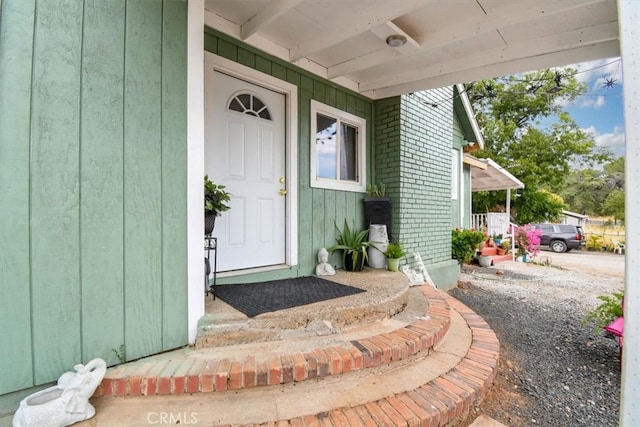 doorway to property featuring covered porch