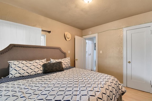 bedroom with hardwood / wood-style flooring