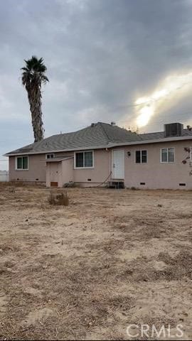 back of house featuring central AC