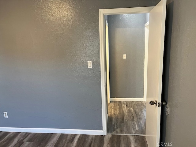 corridor with dark hardwood / wood-style floors