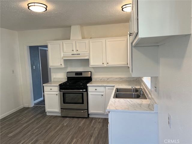 kitchen featuring dark hardwood / wood-style floors, sink, stainless steel gas range, and white cabinets