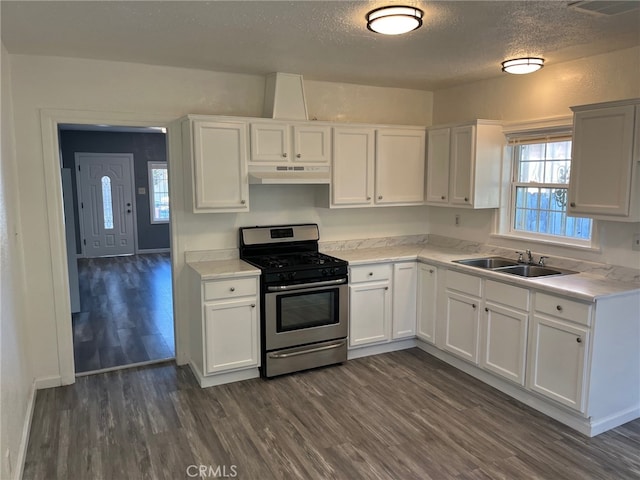 kitchen featuring white cabinetry, sink, stainless steel range with gas stovetop, and dark wood-type flooring