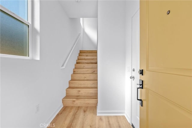 stairs featuring wood-type flooring