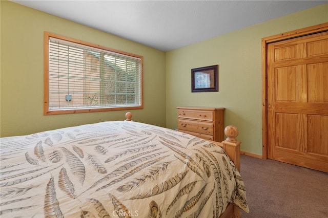 carpeted bedroom featuring baseboards