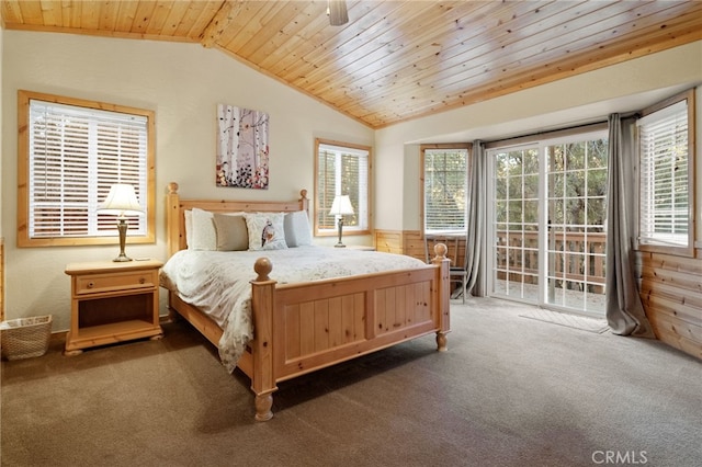 bedroom with a wainscoted wall, vaulted ceiling, wood ceiling, access to outside, and carpet flooring