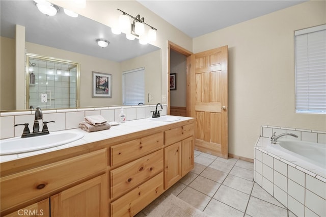 full bathroom with tile patterned floors, a stall shower, a bath, and a sink