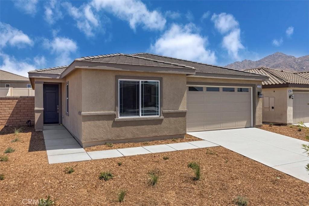 view of front of house featuring a mountain view and a garage