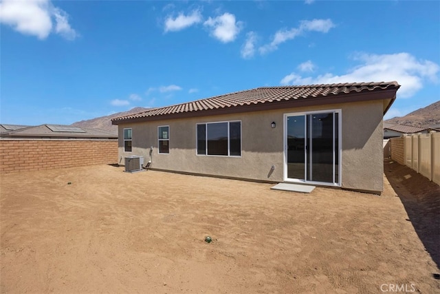 rear view of property featuring central AC unit