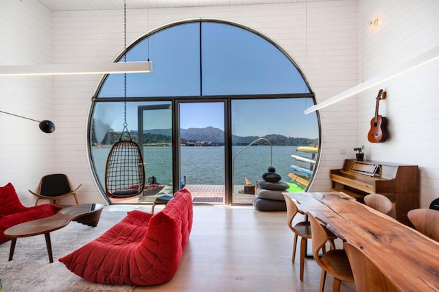 sunroom / solarium featuring a water and mountain view