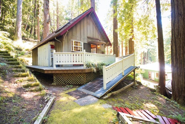 rear view of property featuring a deck