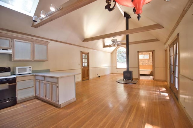 kitchen with beam ceiling, a wood stove, light hardwood / wood-style flooring, kitchen peninsula, and black / electric stove