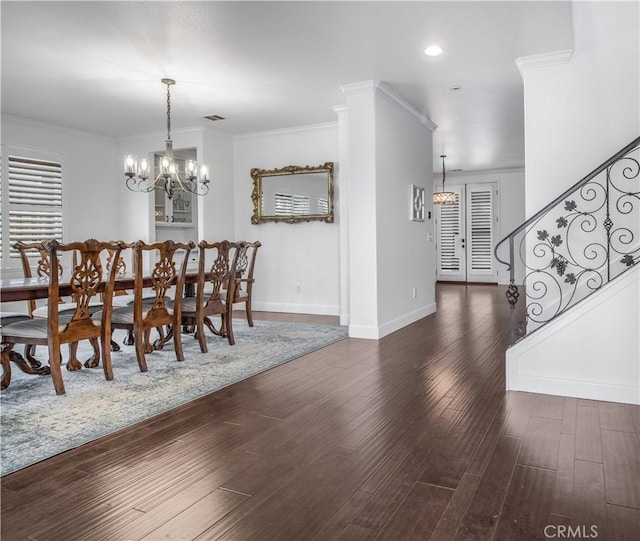 dining room featuring ornamental molding, dark hardwood / wood-style flooring, and an inviting chandelier