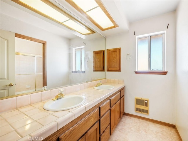8187 Anaconda Ave, Oak Hills, CA 92344 - full bathroom with heating unit, double vanity, a sink, and baseboards