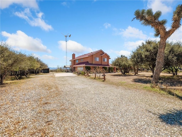 8187 Anaconda Ave, Oak Hills, CA 92344 - view of front facade featuring driveway and a chimney