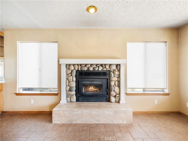 8187 Anaconda Ave, Oak Hills, CA 92344 - interior details with baseboards, a textured ceiling, and a fireplace