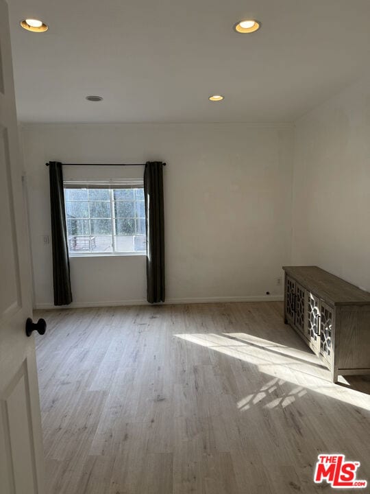 spare room featuring light wood-type flooring