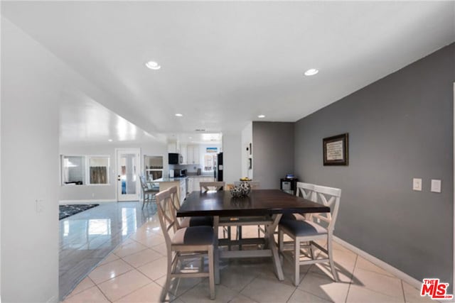 dining area featuring light tile patterned floors