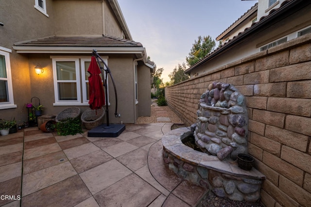 view of patio terrace at dusk