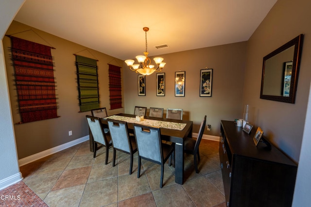 dining room featuring tile patterned flooring and a chandelier