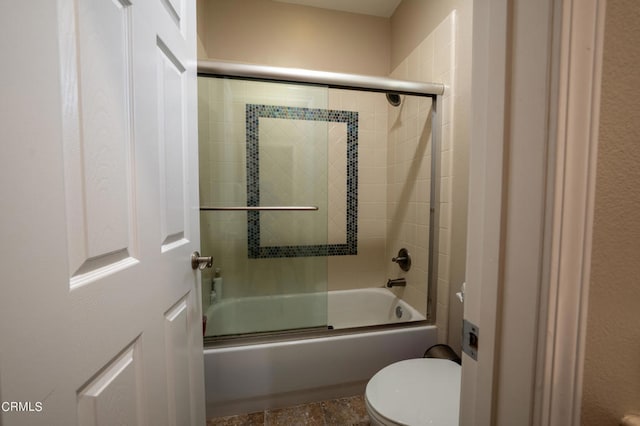 bathroom with enclosed tub / shower combo and toilet