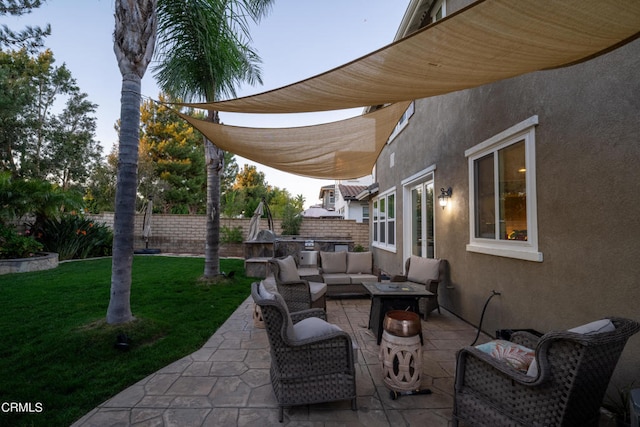 view of patio / terrace with an outdoor living space with a fire pit