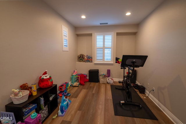 exercise room with hardwood / wood-style flooring