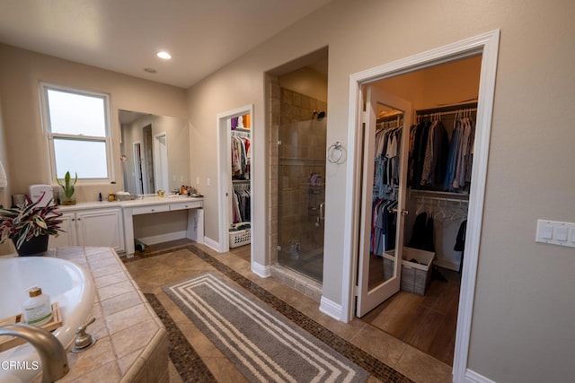 bathroom featuring shower with separate bathtub, vanity, and hardwood / wood-style floors