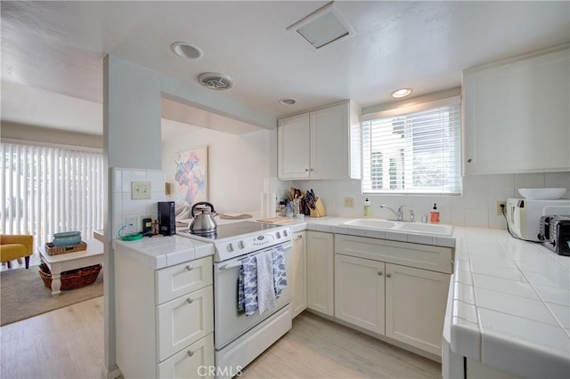 2650 Main St Unit 7, Cambria, CA 93428 - kitchen with white appliances, tile countertops, a sink, decorative backsplash, and recessed lighting