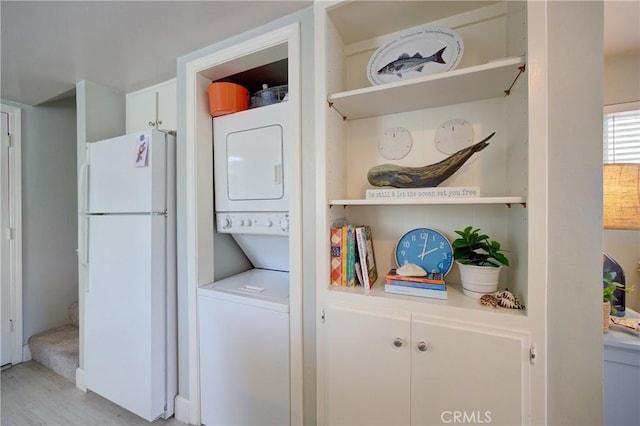 2650 Main St Unit 7, Cambria, CA 93428 - washroom with stacked washer and clothes dryer and light wood finished floors