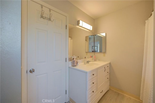 bathroom featuring vanity and hardwood / wood-style flooring