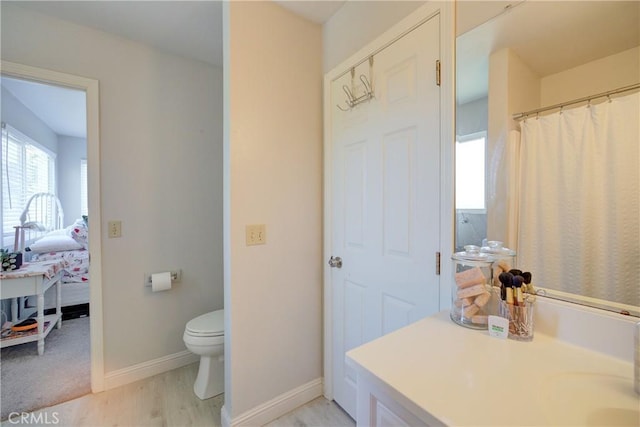 2650 Main St Unit 7, Cambria, CA 93428 - bathroom featuring connected bathroom, toilet, wood finished floors, baseboards, and vanity