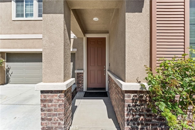 view of exterior entry with a garage