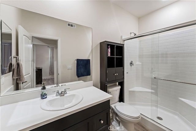 bathroom featuring toilet, walk in shower, vanity, and wood-type flooring