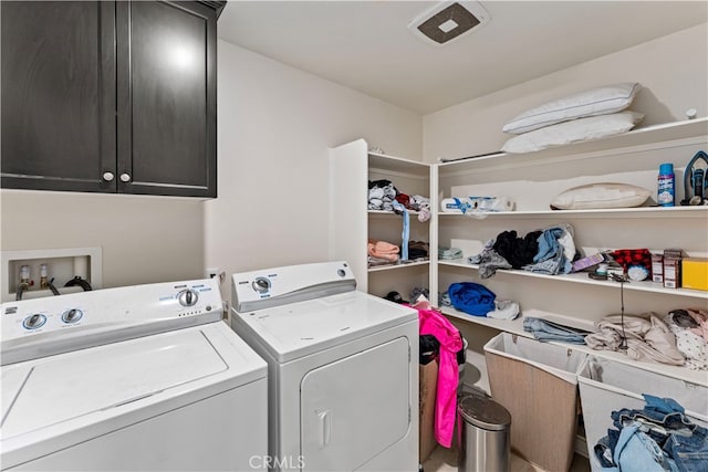 laundry area featuring washing machine and dryer and cabinets