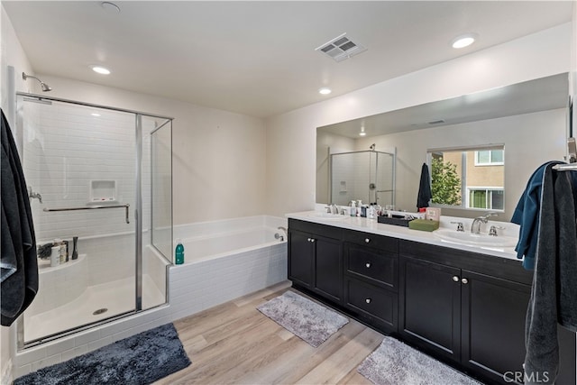 bathroom with vanity, separate shower and tub, and hardwood / wood-style floors