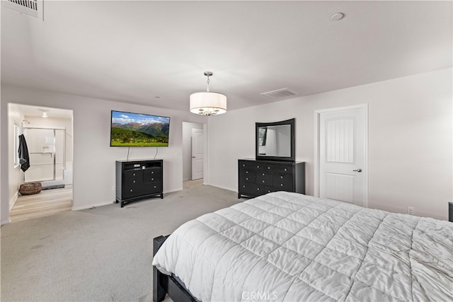 carpeted bedroom with ensuite bath