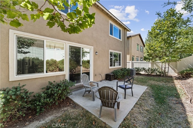 back of house featuring a patio, central AC, and a fire pit