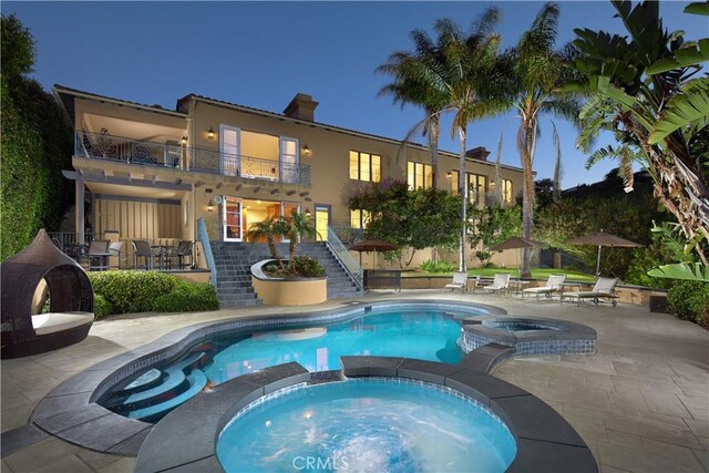 4347 Canyon View Ln, Palos Verdes Peninsula, CA 90274 - pool at night featuring stairway, a pool with connected hot tub, and a patio area