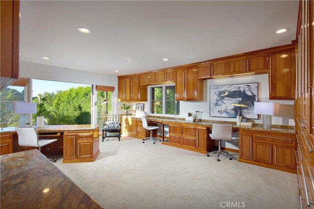 4347 Canyon View Ln, Palos Verdes Peninsula, CA 90274 - kitchen with built in desk, light colored carpet, brown cabinets, recessed lighting, and stone counters
