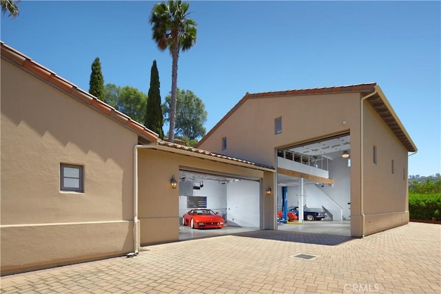 4347 Canyon View Ln, Palos Verdes Peninsula, CA 90274 - view of side of home featuring stucco siding and a garage