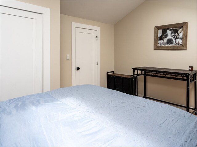 bedroom featuring lofted ceiling