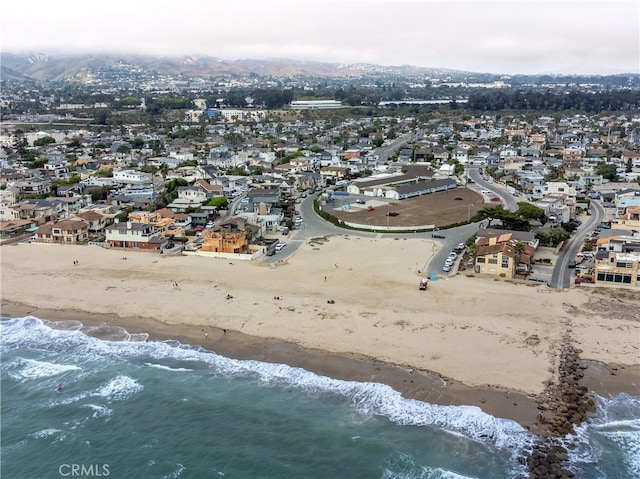 birds eye view of property featuring a water view and a beach view