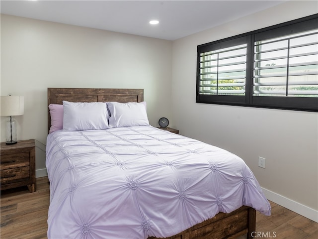 bedroom with hardwood / wood-style floors