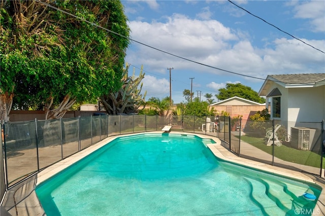 view of pool with central AC and a diving board