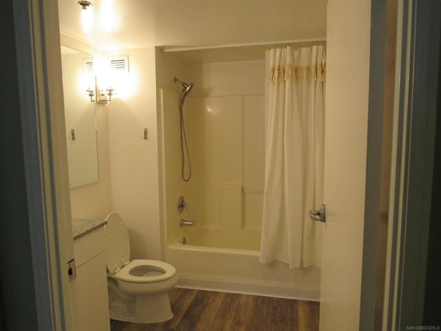 full bathroom with vanity, hardwood / wood-style floors, toilet, and shower / tub combo with curtain