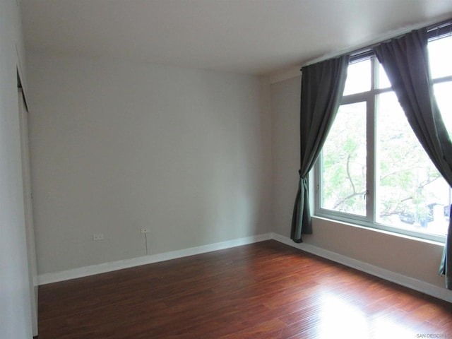 spare room with dark hardwood / wood-style flooring