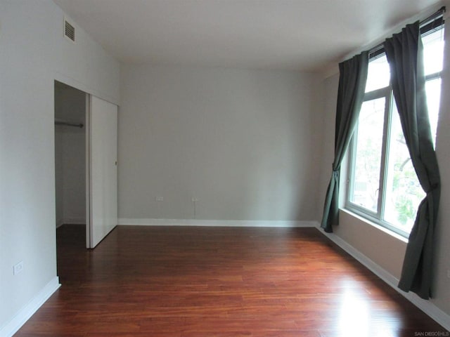 empty room featuring dark wood-type flooring