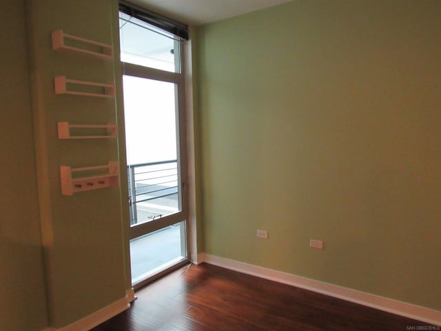 unfurnished room featuring dark hardwood / wood-style floors