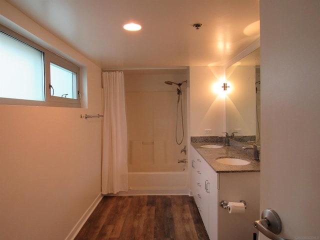 bathroom with shower / bathtub combination with curtain, hardwood / wood-style flooring, and vanity