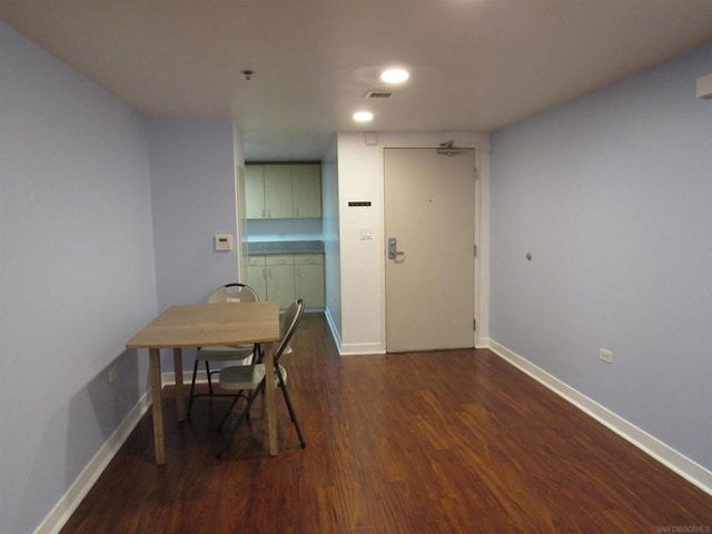 dining space with dark hardwood / wood-style flooring